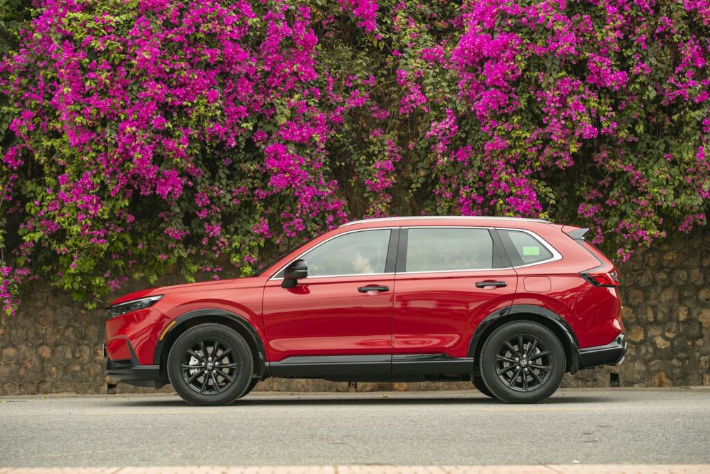 Honda CR-V màu đỏ nhìn ngang bên hoa giấy